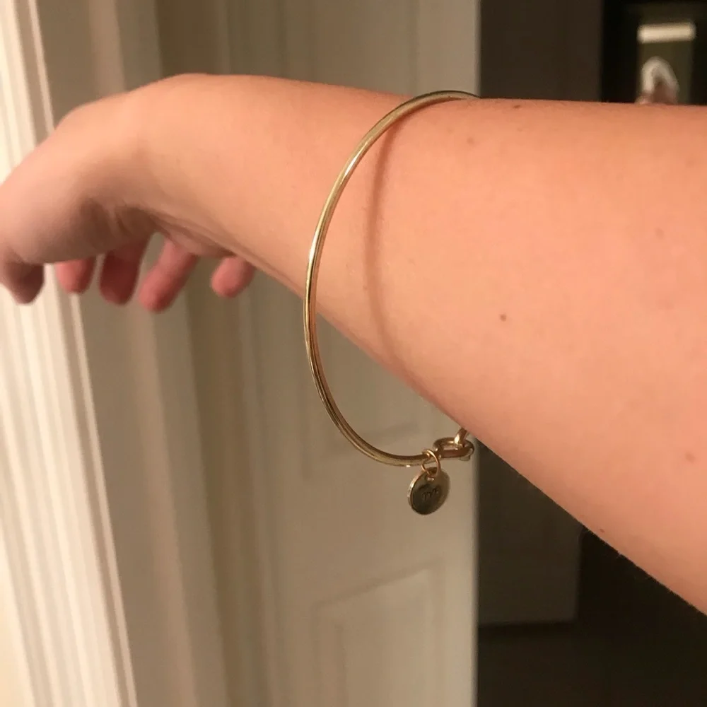 Gold bracelet with M charm